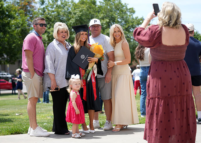 Graduates posing with family